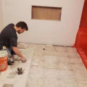 Our Owner Setting a Tile Floor in the Fort Gratiot Area