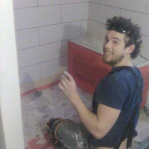 Garret Hard at Work Tile Setting in a Bathroom